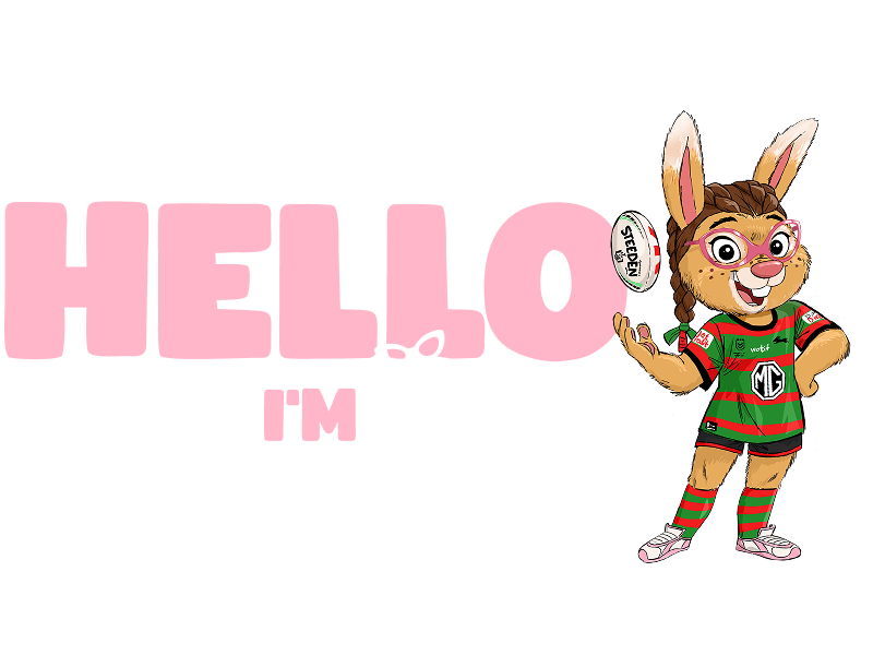 Ruby standing confidently wearing her pink glasses and holding a football